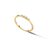Thin, gold-toned open ring with six small, clear round stones set in a curved line on one end.