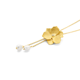 Gold-toned Y-necklace with a textured flower pendant featuring a clear stone, and two dangling white pearls.