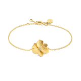 Yellow gold-plated chain bracelet with a central textured jasmine flower motif embellished with small clear stones.