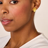 One gold-toned jasmine flower stud earring with textured petals and a clear center stone.