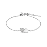 White plated delicate chain bracelet with one pavé-set heart charm and one polished heart charm.