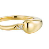 Gold-toned open-ended ring with a smooth, rounded end and a triangular cluster of clear stones where the band meets the round