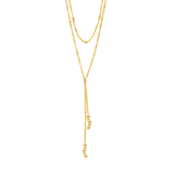 Yellow gold plated Y-shape necklace with delicate chains and spherical beads, some embellished with clear stones.