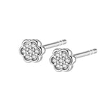 Pair of white plated metal flower stud earrings, each featuring a cluster of clear stones in the centre.