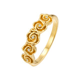 Yellow gold-plated band ring with five rose-shaped embellishments, each featuring a small clear stone.