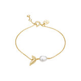 Yellow gold-plated chain bracelet with an off-white baroque pearl and a textured leaf charm featuring a small clear stone.