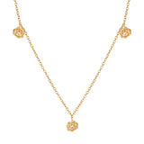 Gold-toned link chain necklace with three rose-shaped charms, each featuring a small clear stone. One charm is a pendant.