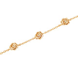 Gold-toned chain bracelet with three sculpted rose charms, each featuring a small clear stone in the center.