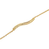 Gold-toned bracelet with a wavy central bar featuring two rows of small, clear, round stones, connected by delicate chains.