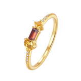 Yellow gold-plated ring with a pear-shaped yellow stone, a rectangular red stone, a square yellow stone, and small white pavé