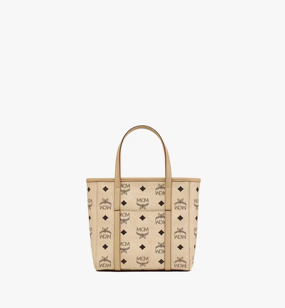 Rear view of the MCM Mini Toni Shopper in beige Visetos canvas featuring a slip pocket and leather trim.