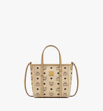 Front view of the MCM Mini Toni Shopper showing the iconic logo plate and the attached crossbody strap.