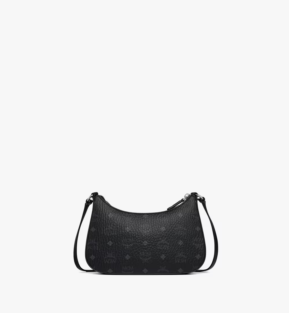 Back view of the small hobo bag highlighting the classic black MCM Visetos monogram on the soft pink coated canvas.