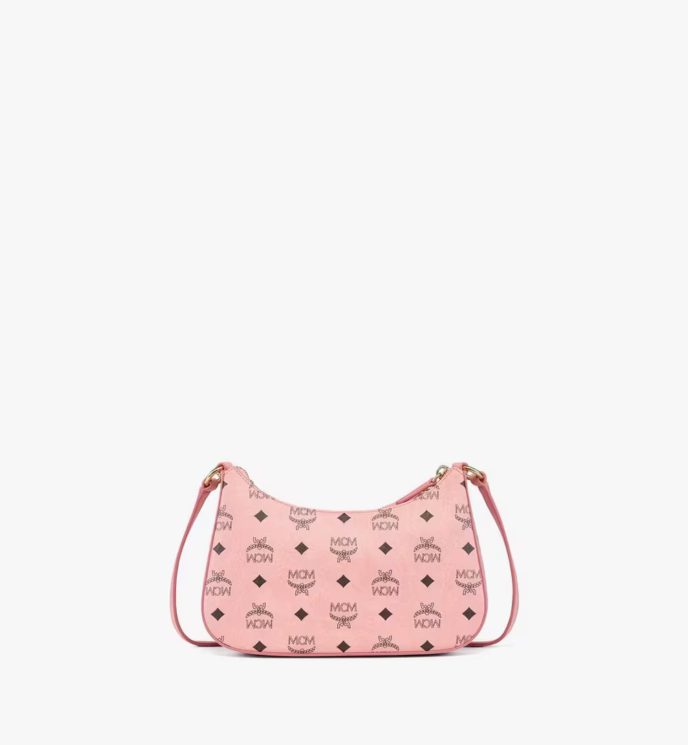 Back view of the small hobo bag highlighting the classic black MCM Visetos monogram on the soft pink coated canvas.