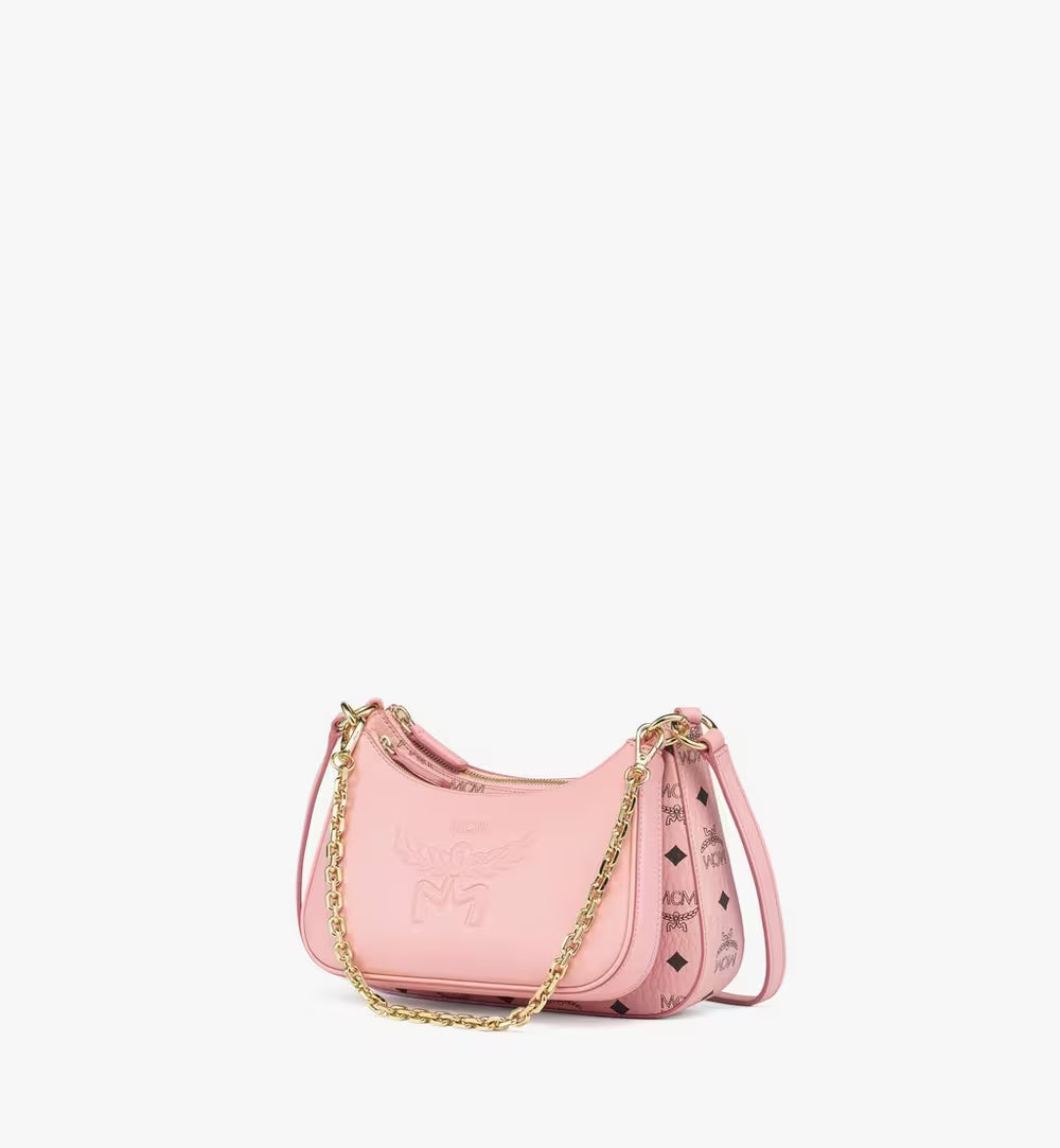 The MCM Aren Duo Hobo set in soft pink, showing the smooth leather pouch attached to the Visetos monogram main bag with a gold chain.