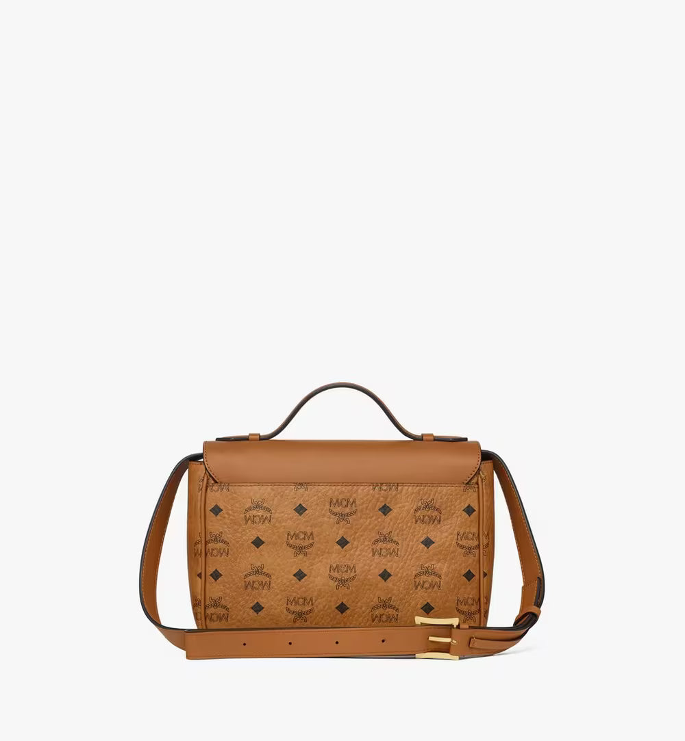 The back of the MCM Tracy Satchel highlighting the continuous Visetos monogram print and the flat leather crossbody strap.