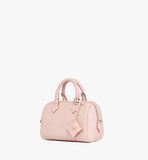 A perspective shot highlighting the structured Boston silhouette and the matching Lotus Pink leather crossbody strap.