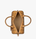 An overhead view showing the bag’s wide-opening two-way gold-tone zipper and spacious interior compartment.