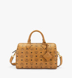 Front view of the MCM Medium Ella Boston Bag in Cognac Visetos featuring rolled leather handles and the signature brass logo plate.