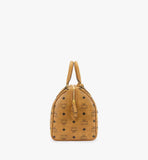 A perspective shot highlighting the structured Boston silhouette and the matching Cognac leather crossbody strap.