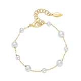 Gold-toned chain bracelet with white simulated pearls of varying sizes, lobster clasp, and adjustable extension chain.
