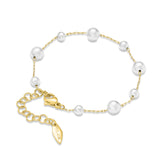 Gold-toned chain bracelet with white pearls of varying sizes, a lobster clasp, and an extender chain with a 'POLICE' charm.