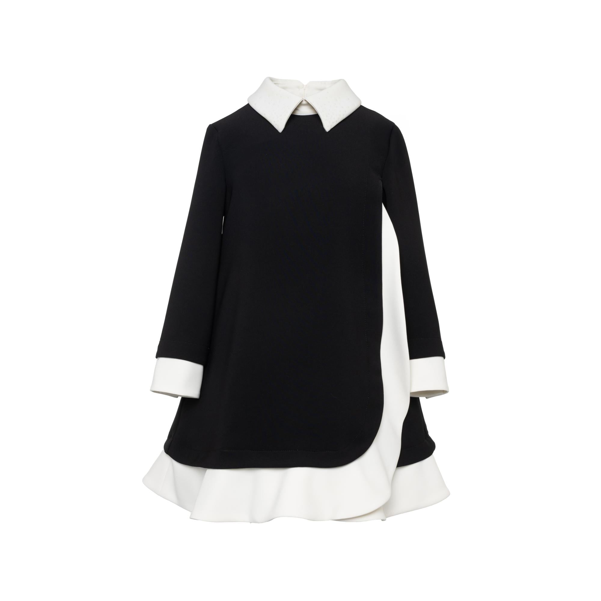 Black and white A-line dress with a pointed Peter Pan collar, long sleeves, and a layered skirt with a curved hem.
