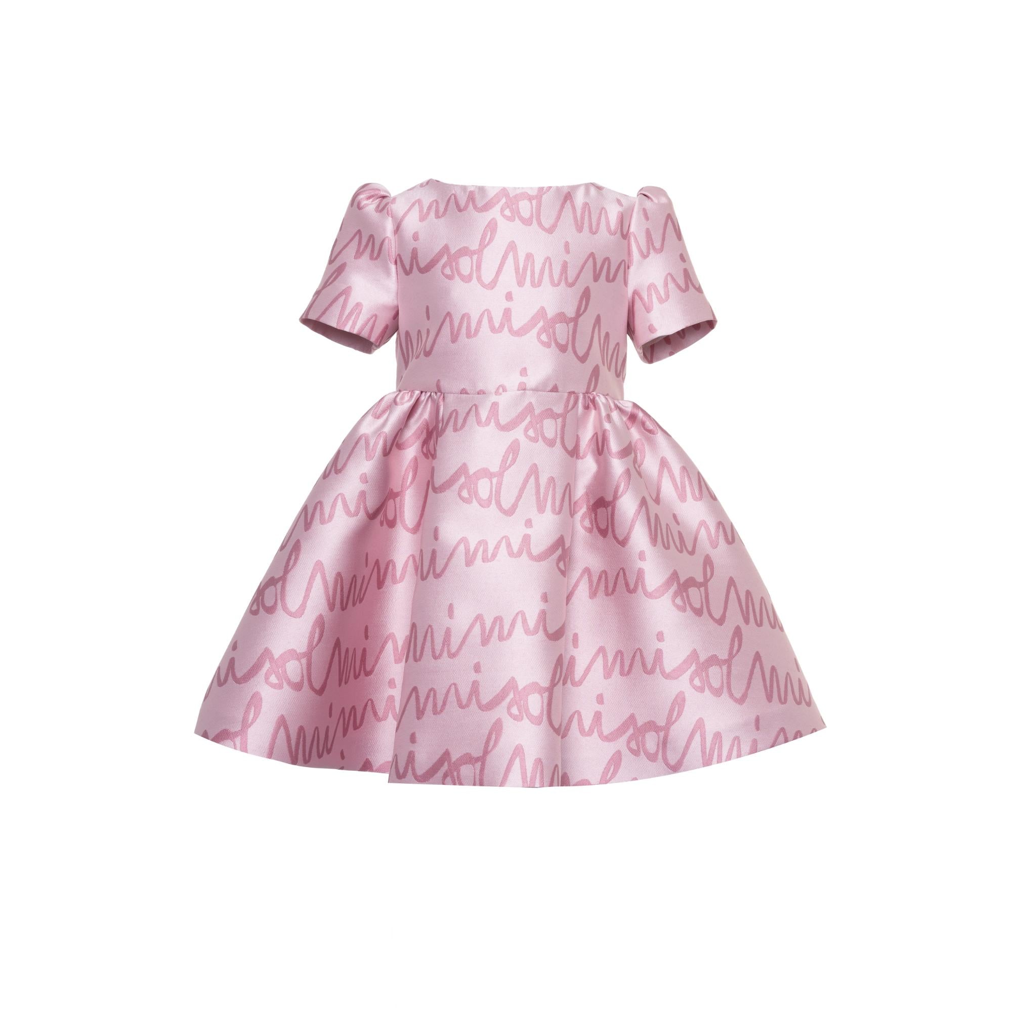 Pink girls' dress with short puffed sleeves and a full, flared skirt, featuring an all-over lighter pink cursive "mimisoli" p