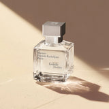 Square clear glass perfume bottle with a silver-toned square cap. Black text on the front reads 'Maison Francis Kurkdjian Par