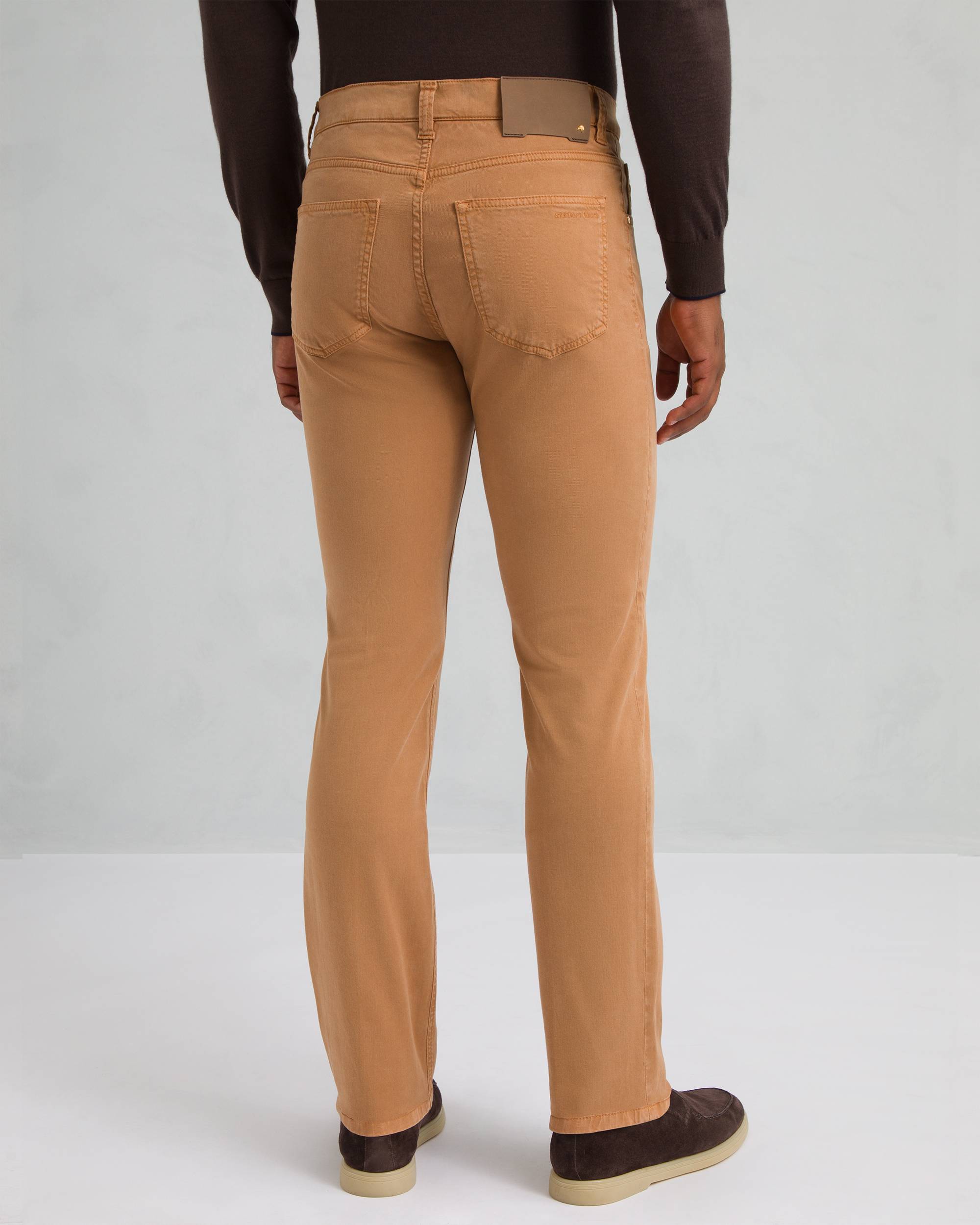 Camel brown straight-leg trousers with two back patch pockets, belt loops, and a brown leather-like waistband patch with a go