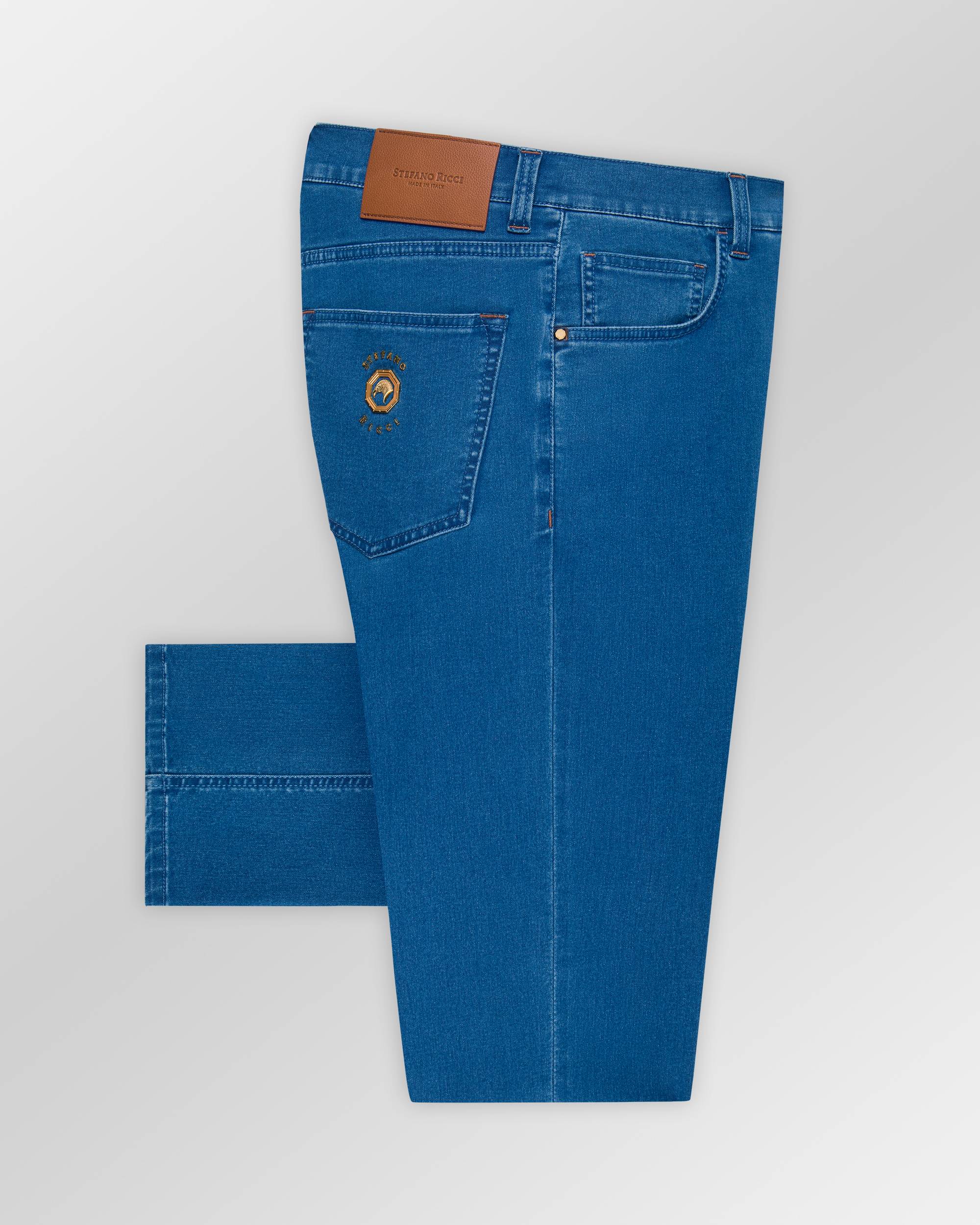 Blue classic wash jeans with a brown leather waistband patch, an embroidered logo on the right back pocket, and a gold-toned