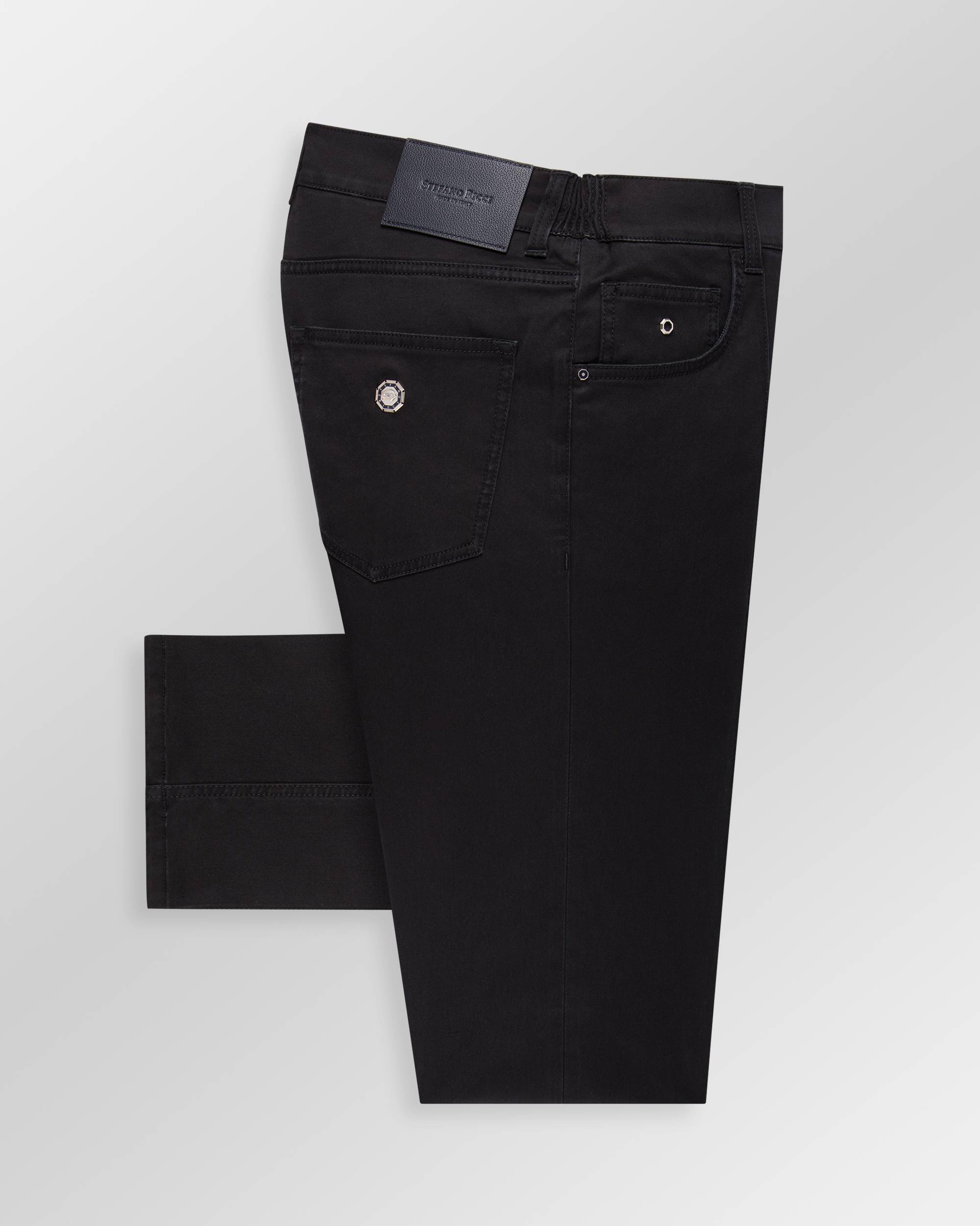 Black dark wash trousers with a dark blue leather waistband patch, a silver-toned emblem on the back right pocket, and silver