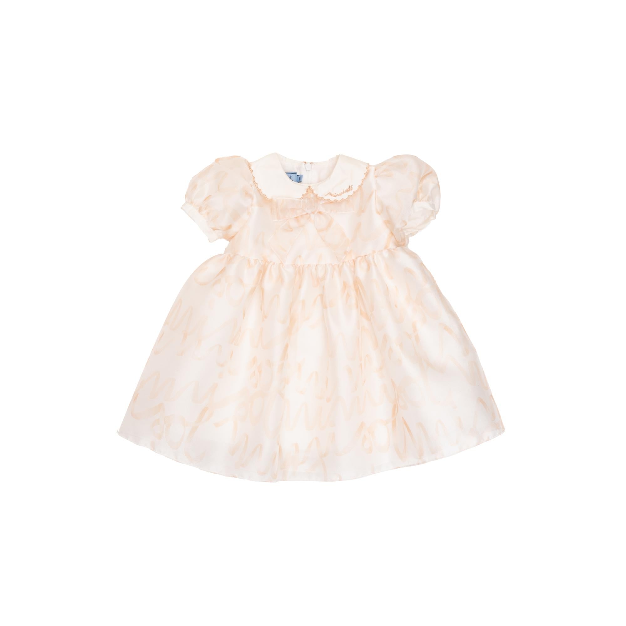 Light pink baby dress with puffed sleeves, white Peter Pan collar with embroidery, a small bow, and a subtle patterned overla