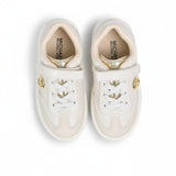 Directly overhead bird's-eye view looking inside a pair of kids' Michael Kors running shoes, showcasing black insoles with white printed logos and white athletic lacing.