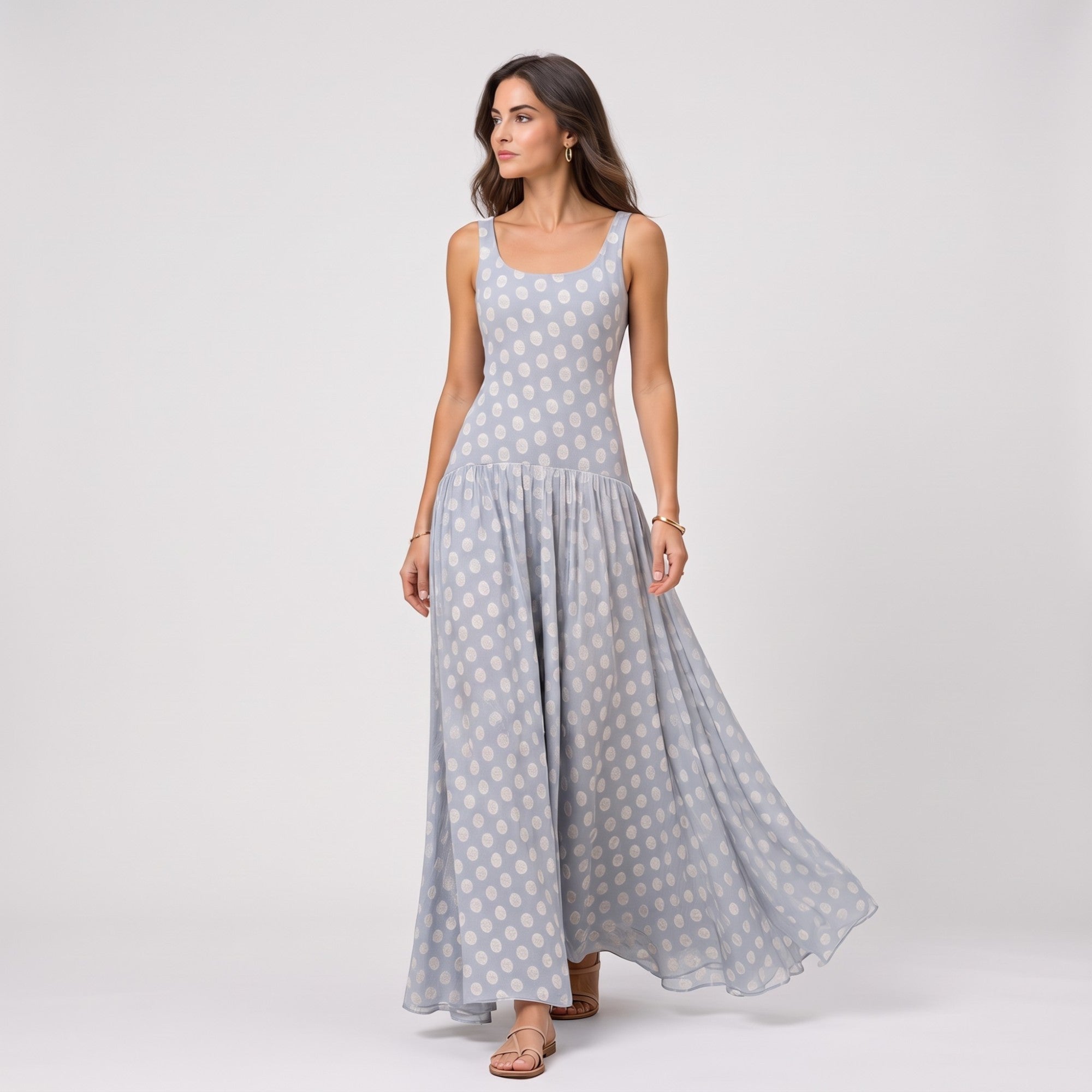 Light blue sleeveless maxi dress with a scoop neck, fitted bodice, and gathered waist, featuring an all-over light polka dot
