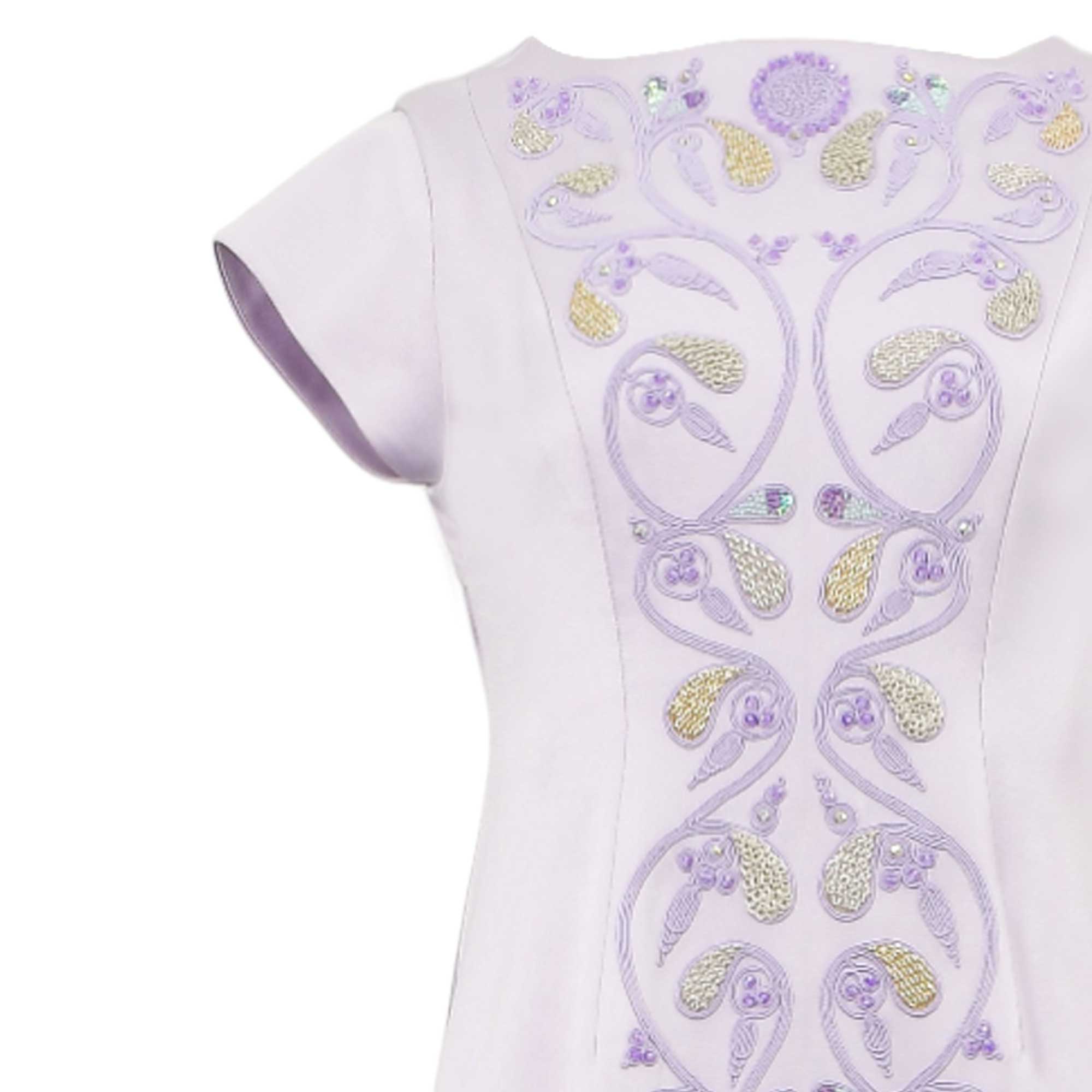 Lavender dress with short sleeves. The bodice has ornate purple embroidery accented with gold-toned, silver-toned, and irides