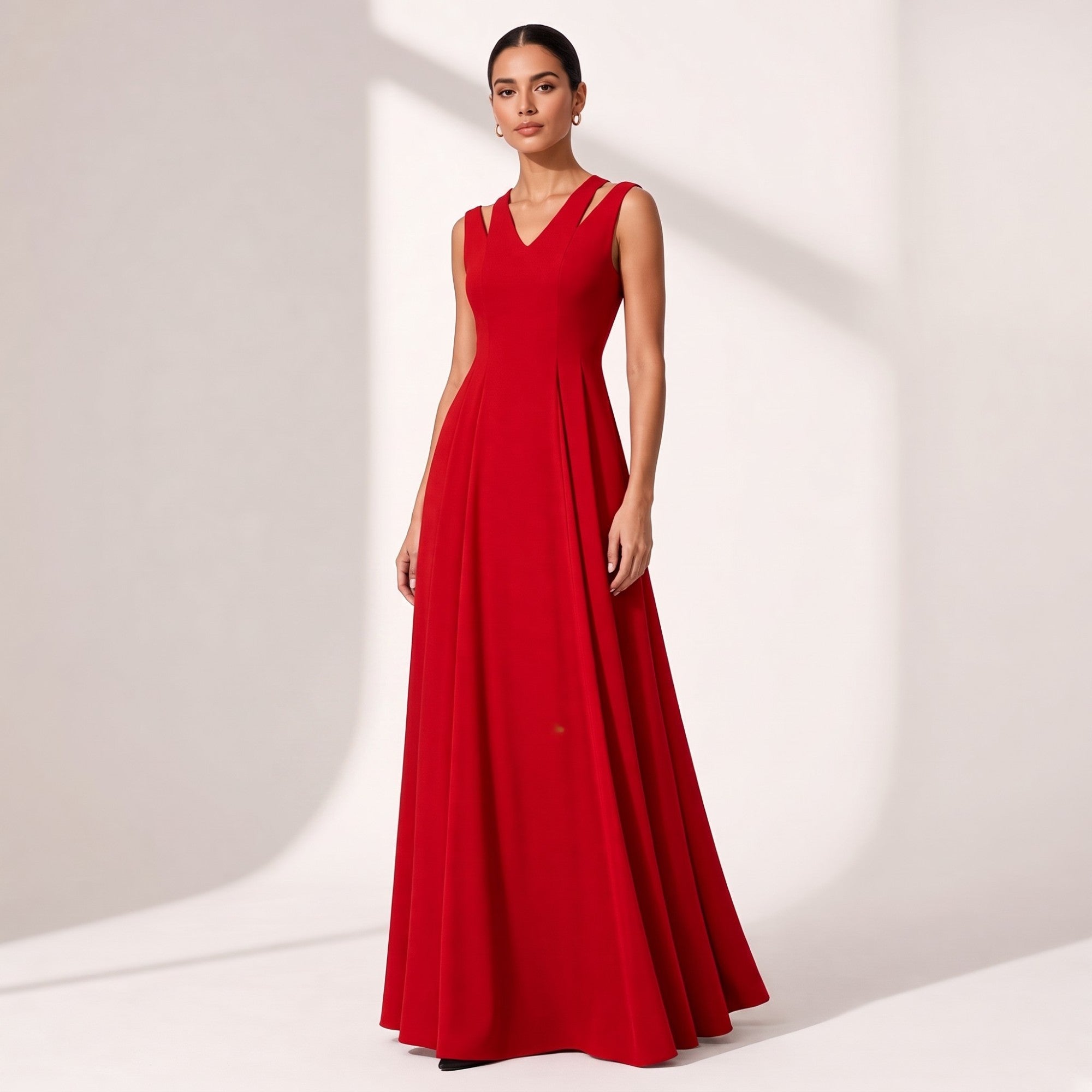 Red sleeveless V-neck dress with V-cutout shoulder straps, a fitted bodice, and a full, flowing floor-length skirt.