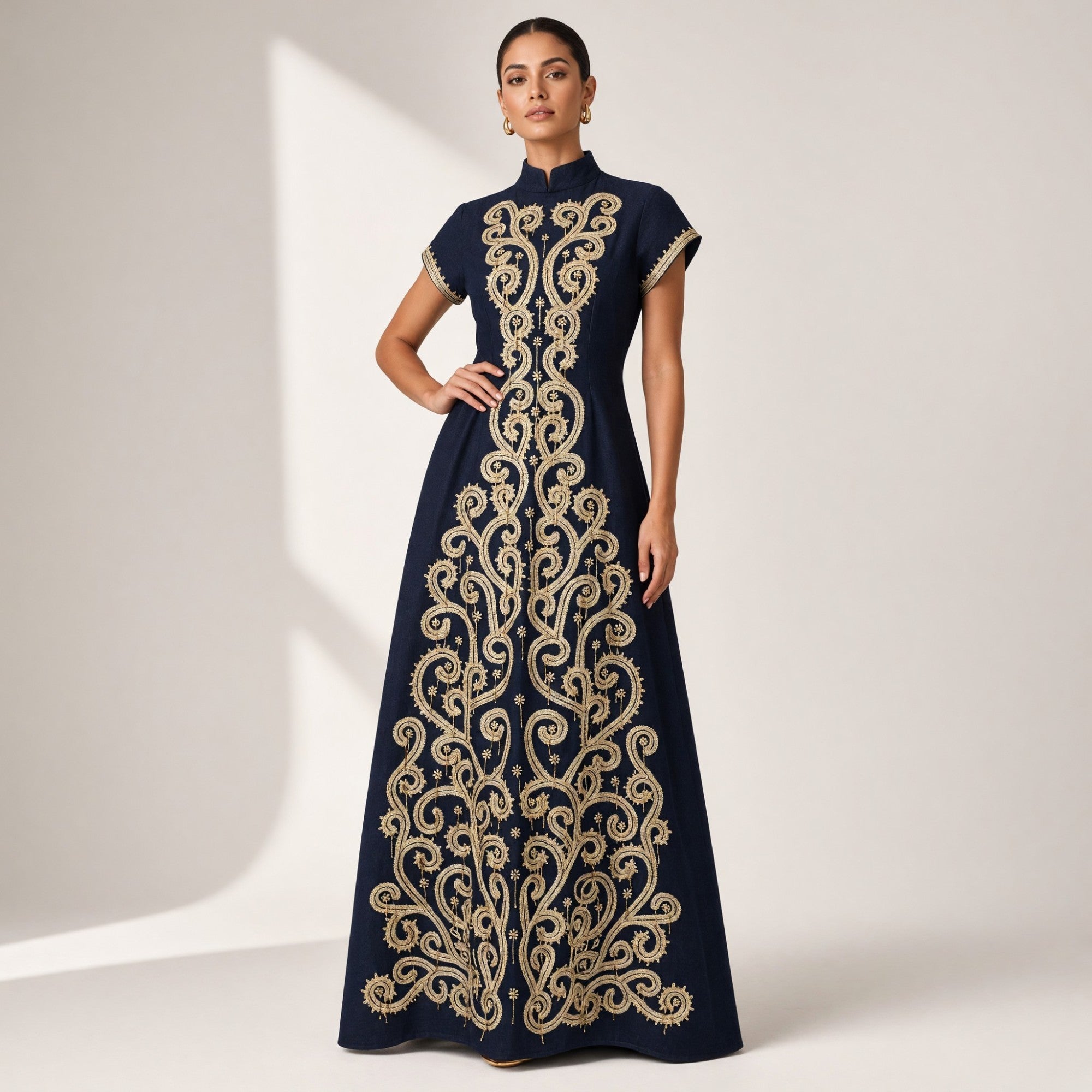 Navy floor-length dress with a high collar and short sleeves, featuring extensive gold-toned ornate swirling embroidery down