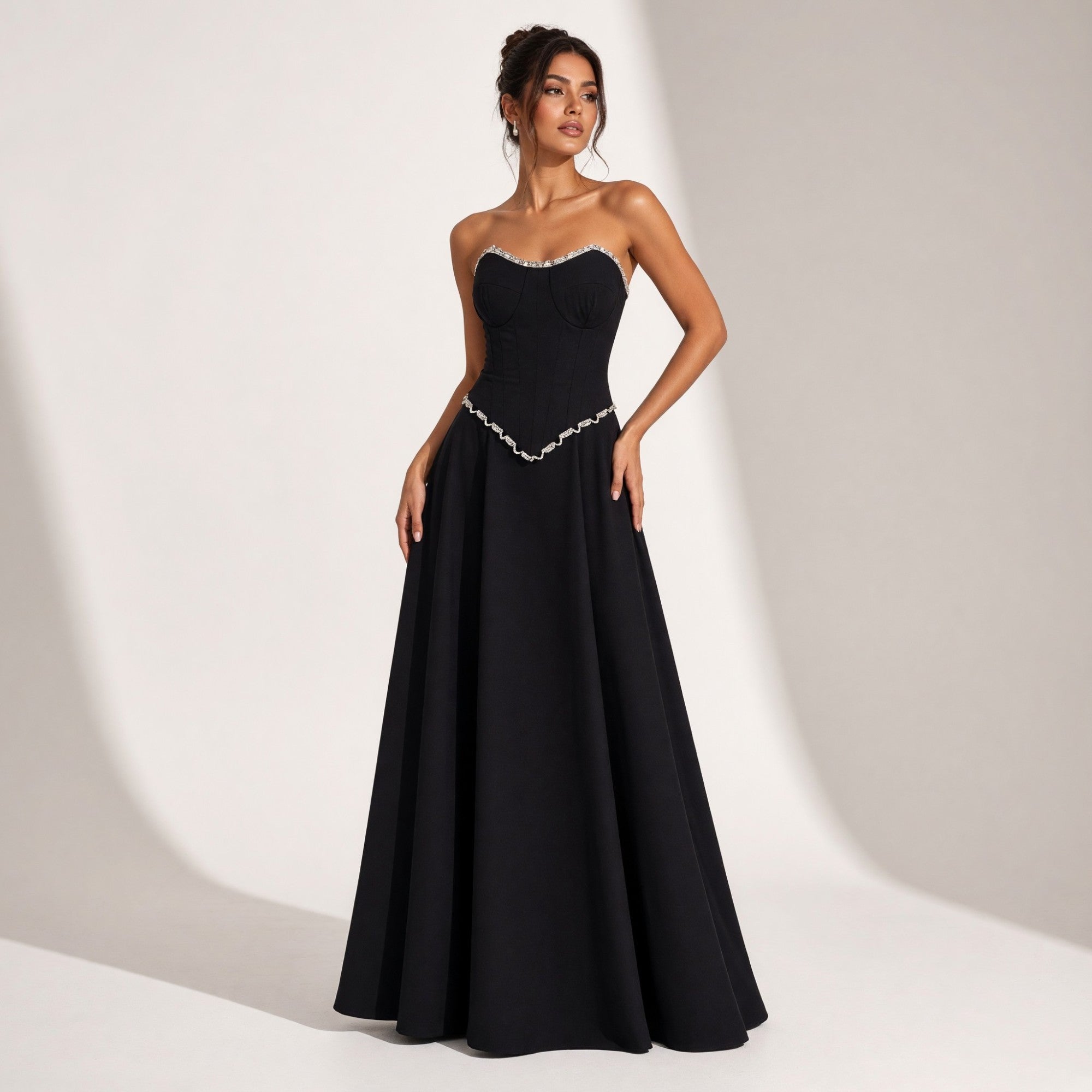 Black strapless sweetheart top with silver-toned beaded trim, corset-style bodice, and a matching full A-line skirt with V-sh