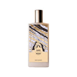 A white bottle of Memo Paris Zante Eau de Parfum standing next to its tan textured presentation box. The bottle features a colorful, abstract illustration of coastal rock formations.