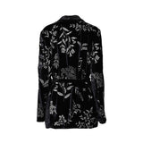 Black velvet embroidered jacket by MOMONI with floral detailing, shawl collar, and adjustable tie waist.