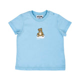 Close-up of the light blue Moschino Baby T-shirt highlighting the central Teddy Bear and cloud motif.