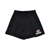 Detailed view of the black jersey shorts featuring a wide elastic waistband and the Moschino bear logo on the left leg.