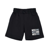 Front view of Moschino kids' black jersey shorts with elastic drawstring waist and white leg logo.