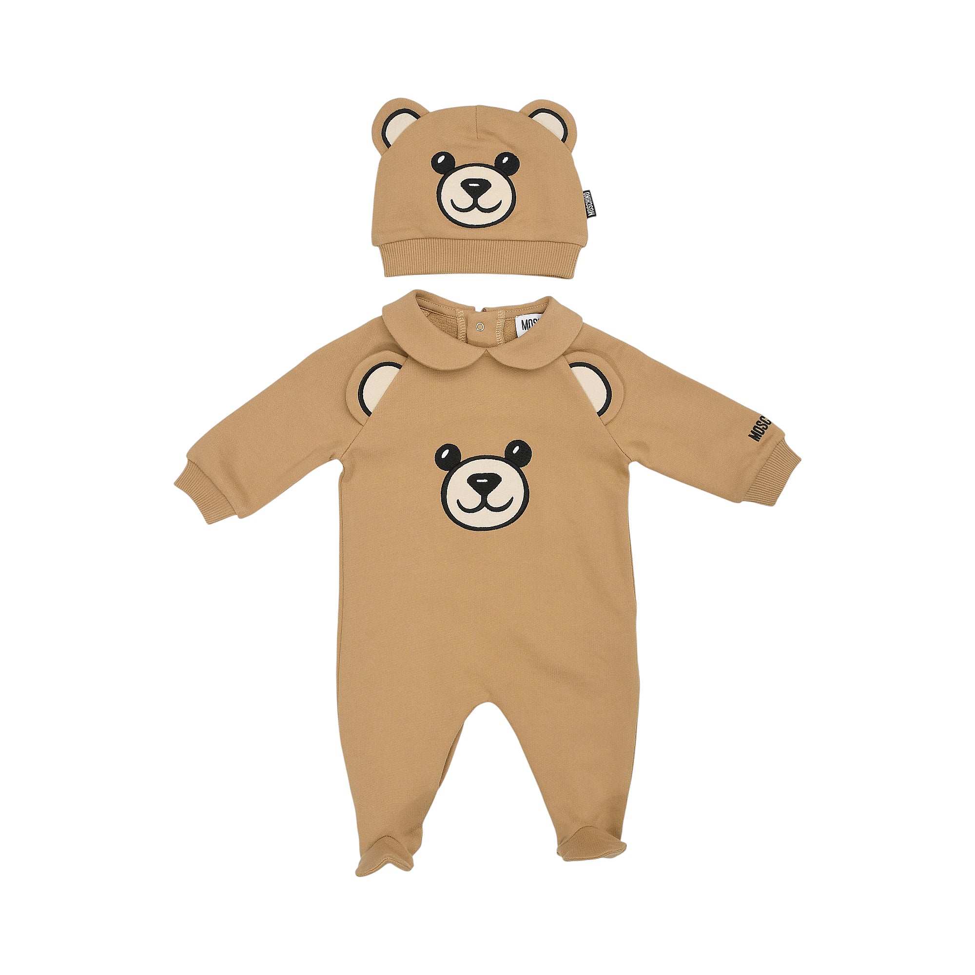 Brown Moschino Kids long-sleeved, footed sleepsuit with bear face graphic and matching beanie hat with bear ears.