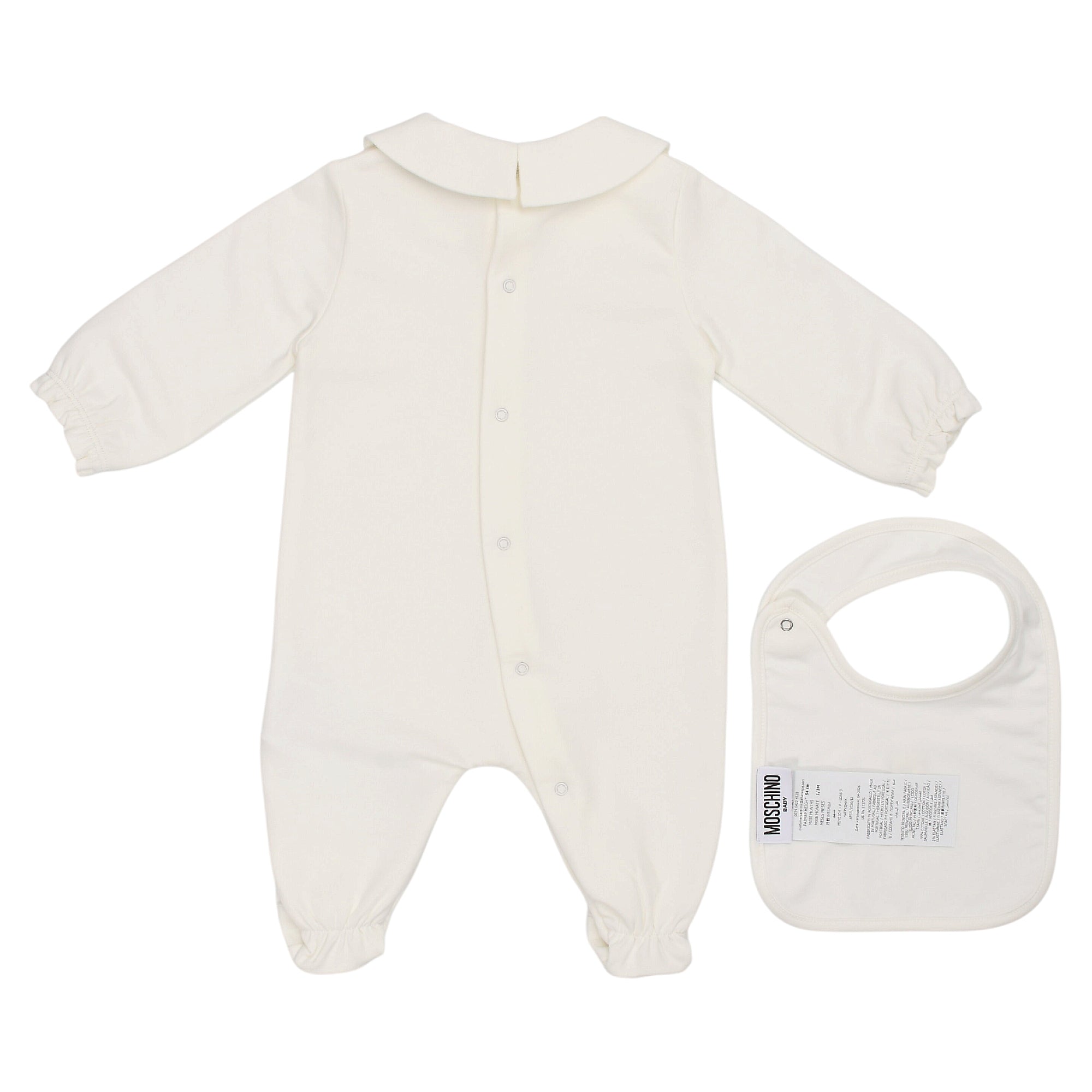 White footed sleepsuit with rounded collar, snap front, and gathered cuffs/ankles. White bib with snap closure and Moschino l