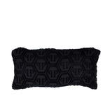 Black textured pillow with a pattern on a white background.