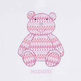 Close-up view of the front of a white Missoni t-shirt, showing a pink embroidered-style teddy bear filled with a chevron pattern and the brand name below.