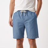 Light blue chambray men's shorts with an elasticated waistband, white drawstring, and side pockets.