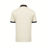 Off-white short-sleeve polo shirt, back view, with a dark brown collar and dark blue ribbed cuffs.